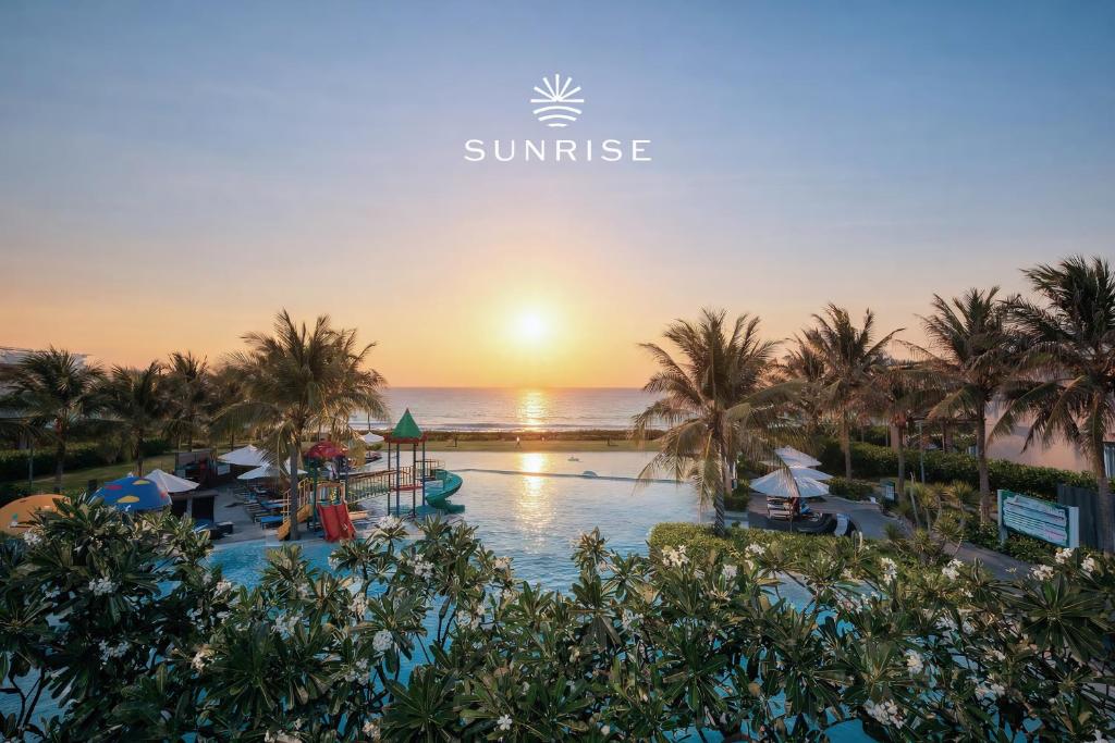 an aerial view of a resort with a pool and the ocean at Sunrise Pool Villa Cam Ranh in Cam Ranh