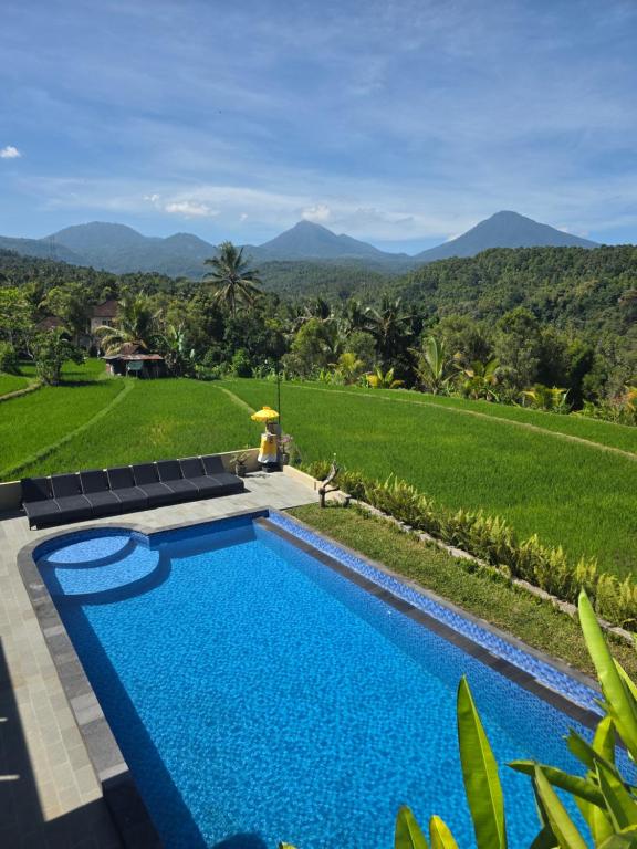 a swimming pool with a view of the mountains at Bukit Luwih House in Munduk