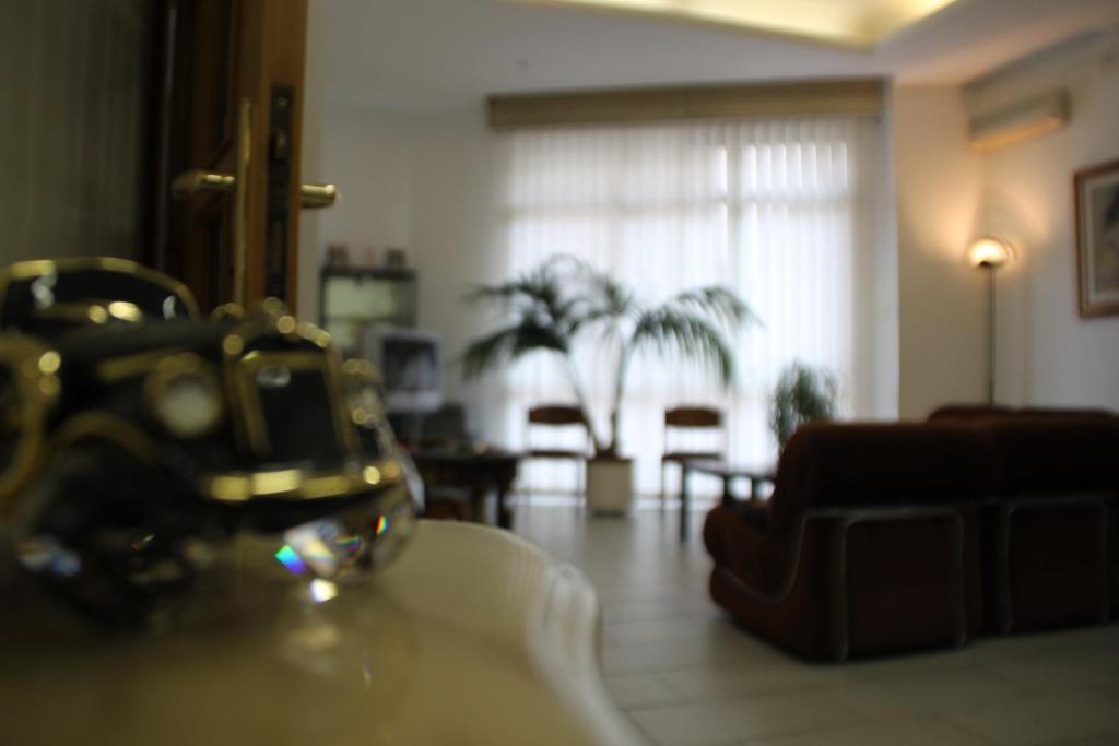 a living room with a couch and a table at Albergo Europa in Vittoria