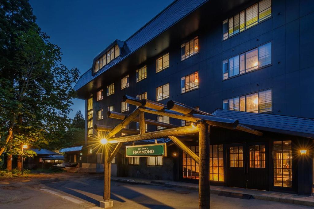 a building with a street sign in front of it at Takamiya Hotel Hammond in Zaō Onsen