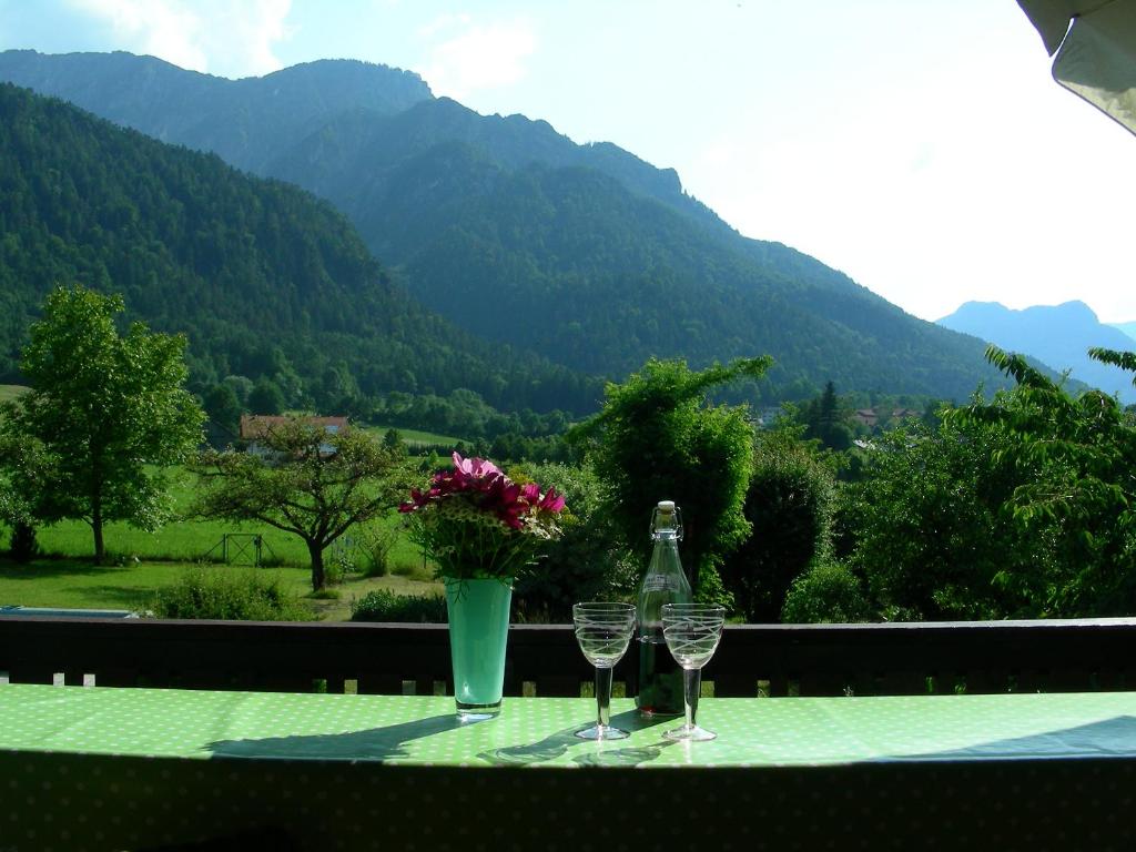 a table with two glasses and a bottle of wine at Ferienwohnung Guder in Bayerisch Gmain