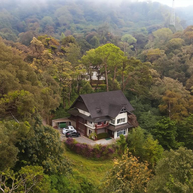 an aerial view of a house in the middle of a forest at The Raarees Mist Resort, Munnar - Nested in Nature's Lap in Munnar