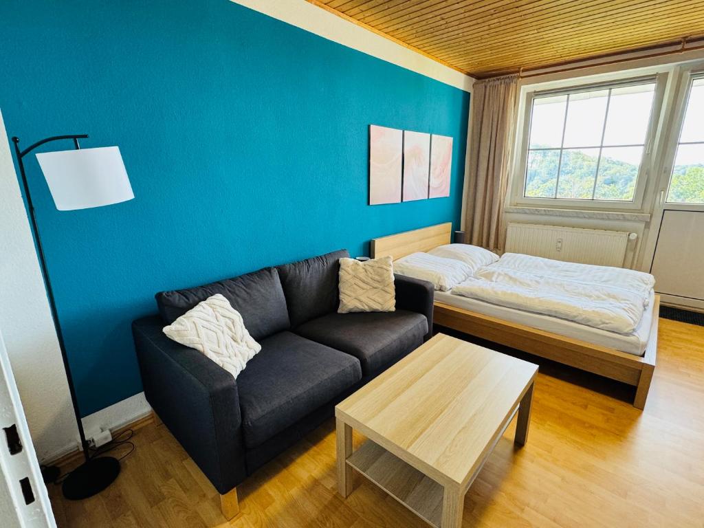 a living room with a couch and a bed at FeWo Einetal 1 im schönen Ostharz in Harzgerode
