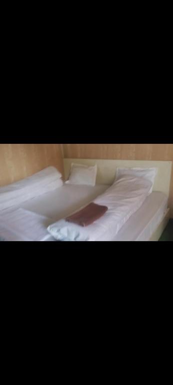 a bed with white sheets and a red blanket at Inaya resort in Phata