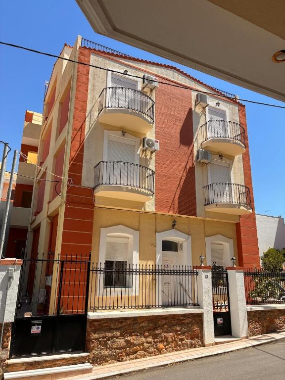 a building with balconies on the side of it at M A Apartments in Chios