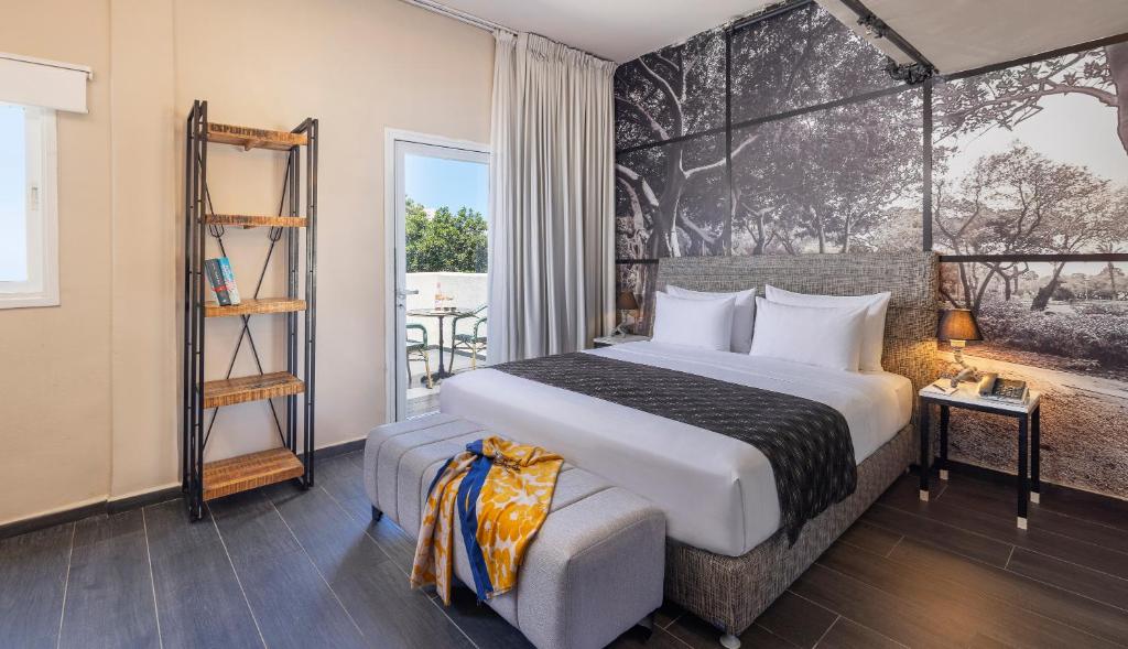 a bedroom with a large bed and a window at Dizengoff Avenue Boutique Hotel - by Echo Hotels in Tel Aviv
