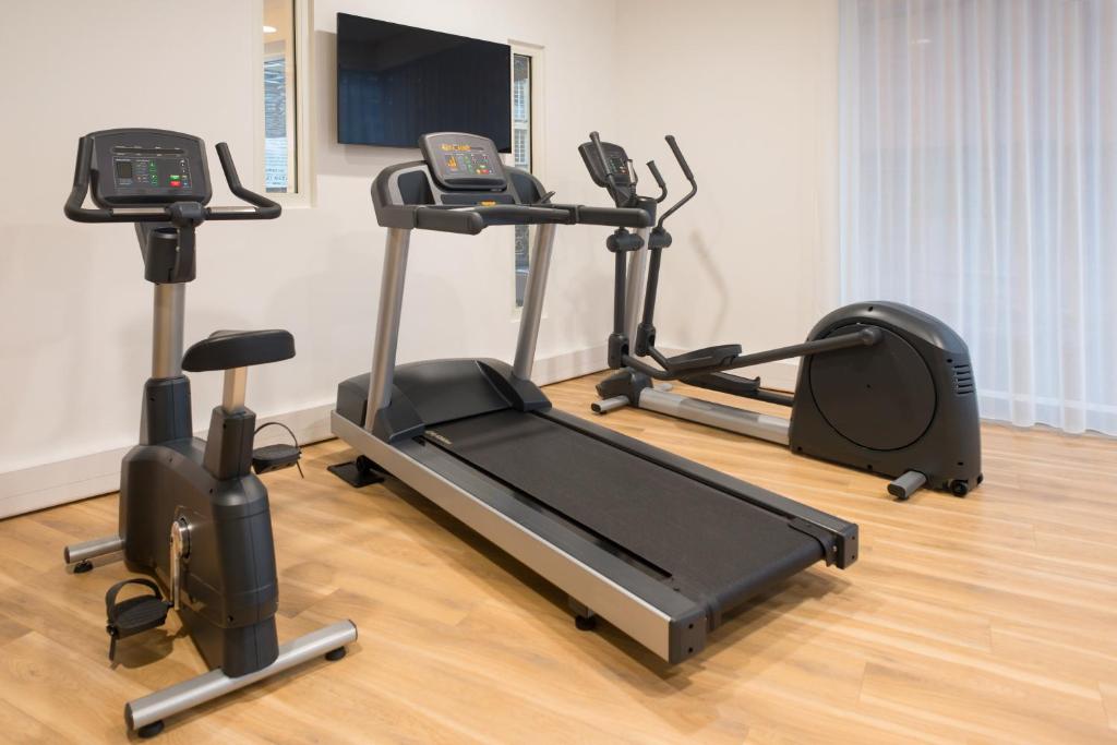 a gym with three exercise bikes and a treadmill at Aparthotel Adagio Birmingham City Centre in Birmingham