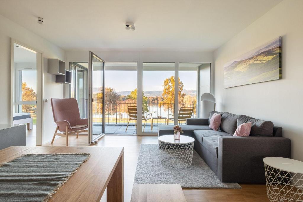 a living room with a couch and a table at Ferienwohnung Badespaß am Schlosssee Salem in Salem