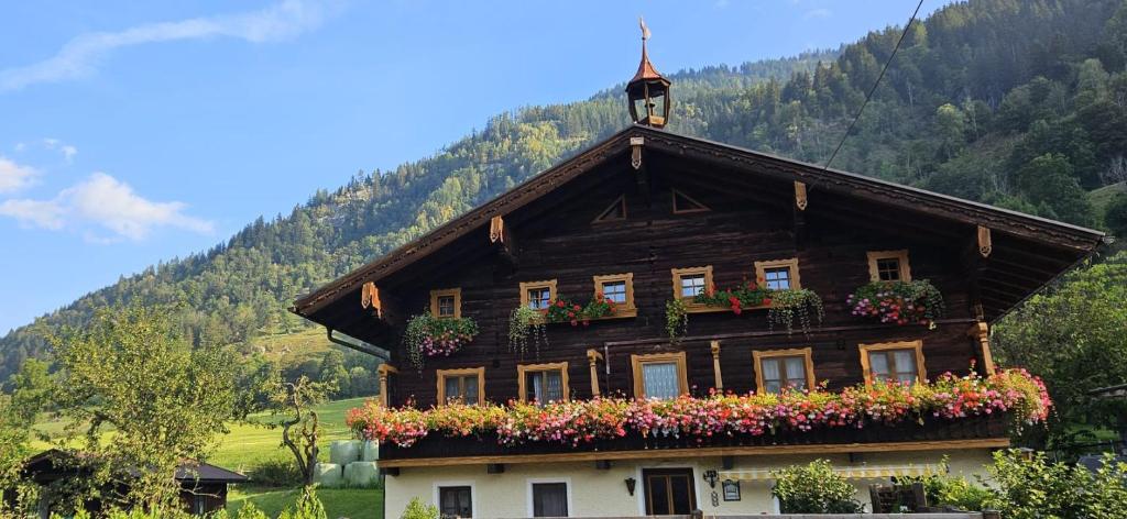 a house with flowers on the side of it at Steinerbauer in Dorfgastein