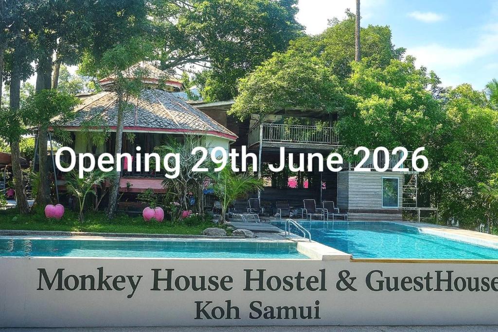 a sign for a monday house hostel and guest house at Monkey House Hostel & Guest House Koh Samui in Chaweng Noi Beach