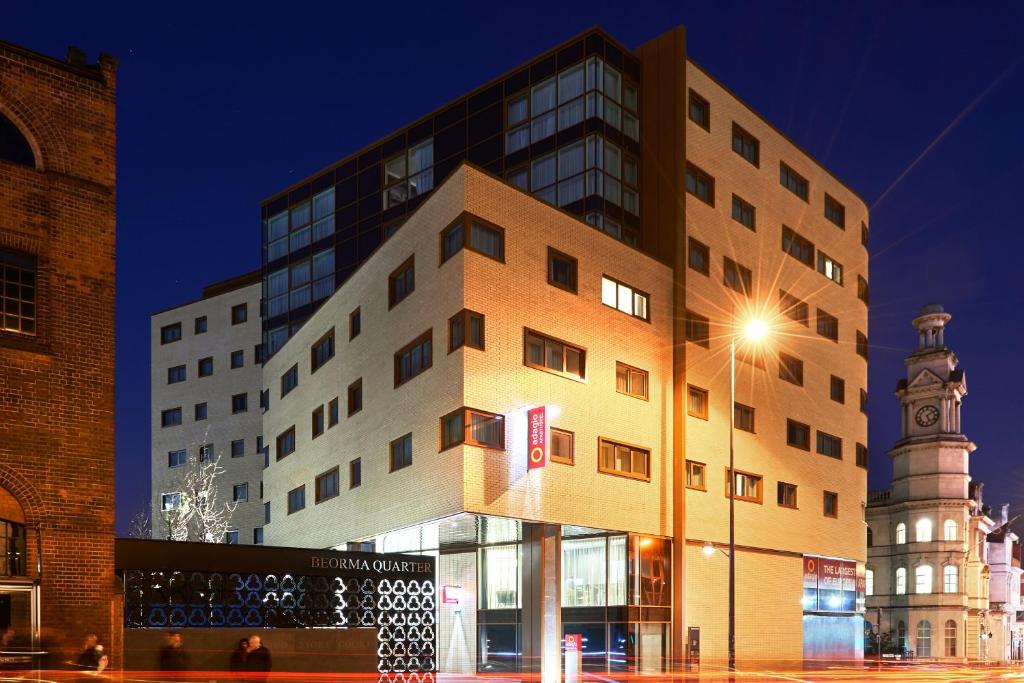 a building with a clock tower and a street light at Aparthotel Adagio Birmingham City Centre in Birmingham