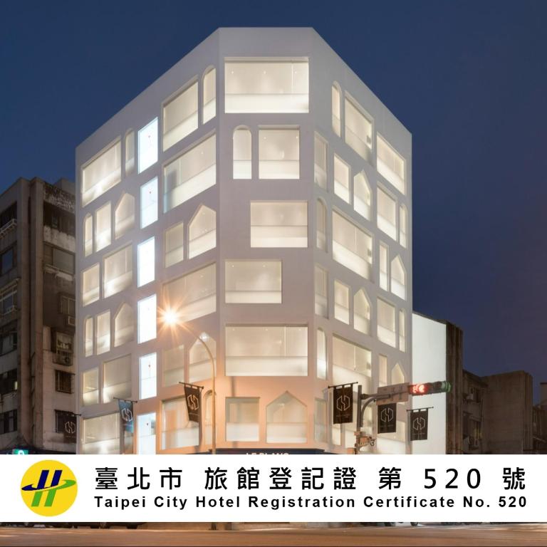 a tall building with a street light in front of it at Swiio Hotel Daan in Taipei
