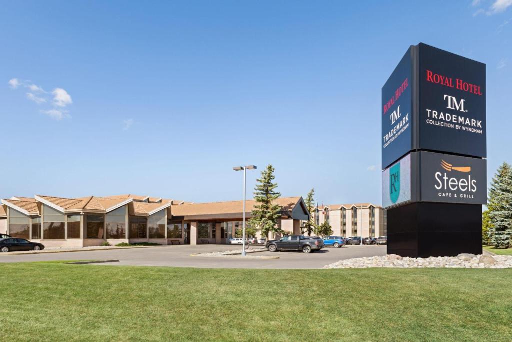 a sign in front of a building with a parking lot at Royal Hotel West Edmonton, Trademark Collection by Wyndham in Edmonton