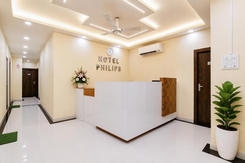 an office lobby with a reception desk and a sign that reads hotel pillars at Hotel Philips in Kolkata