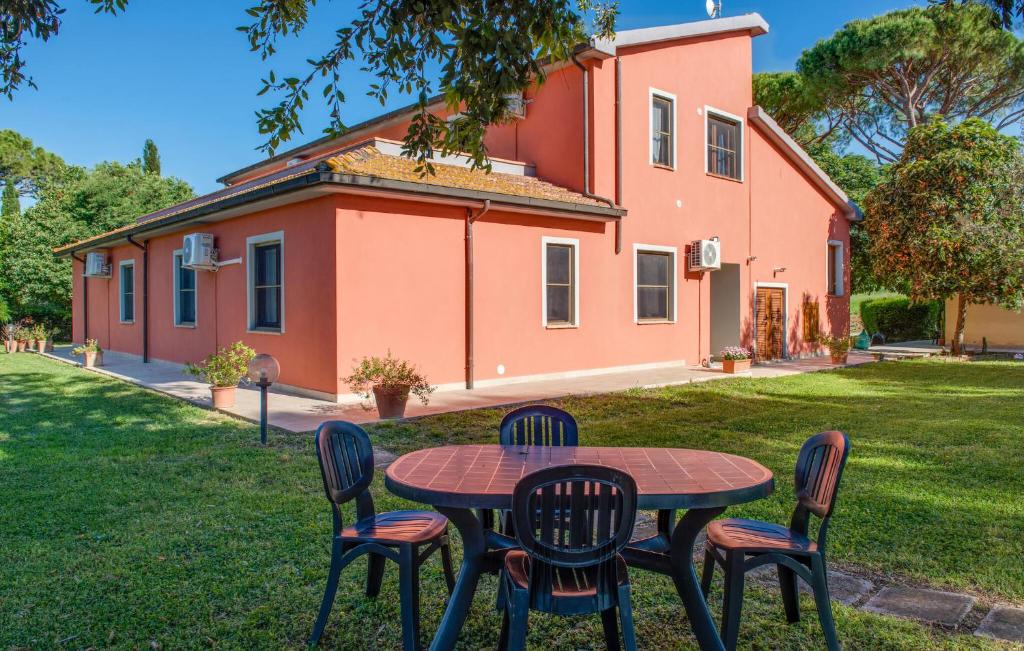 a table and chairs in front of a house at Awesome Apartment In Roccastrada in Roccastrada