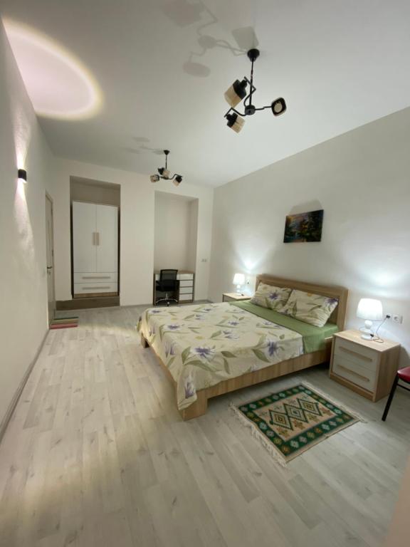 a large bedroom with a bed and a table at Green Home on Mtatsminda in Tbilisi City