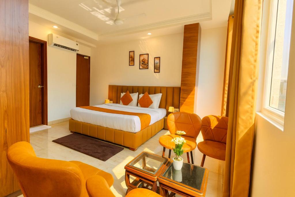 a hotel room with a bed and a chair at Hotel La Casa, Amritsar #swimming pool #prime location #luxury rooms #best selling hotel near golden temple in Amritsar