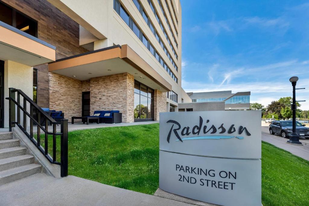 a building with a sign for parking on and street at Radisson Hotel La Crosse in La Crosse