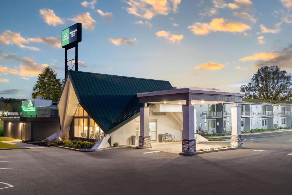 a gas station in front of a hotel at Wingate by Wyndham Geneva at SPIRE Academy in Geneva