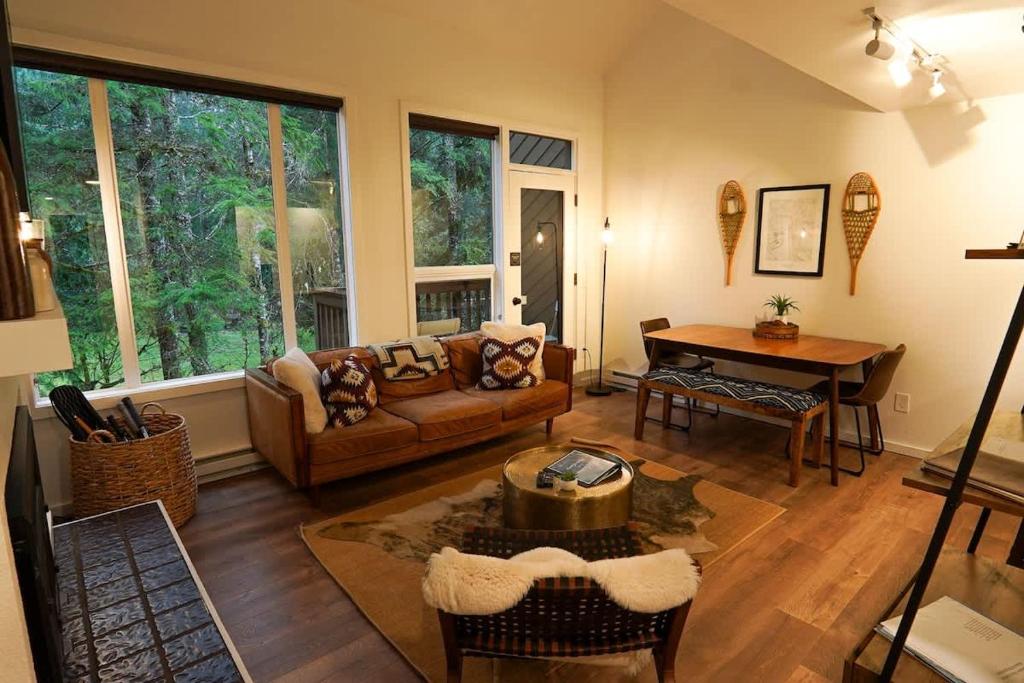 a living room with a couch and a table at Riversong Retreat in Glacier