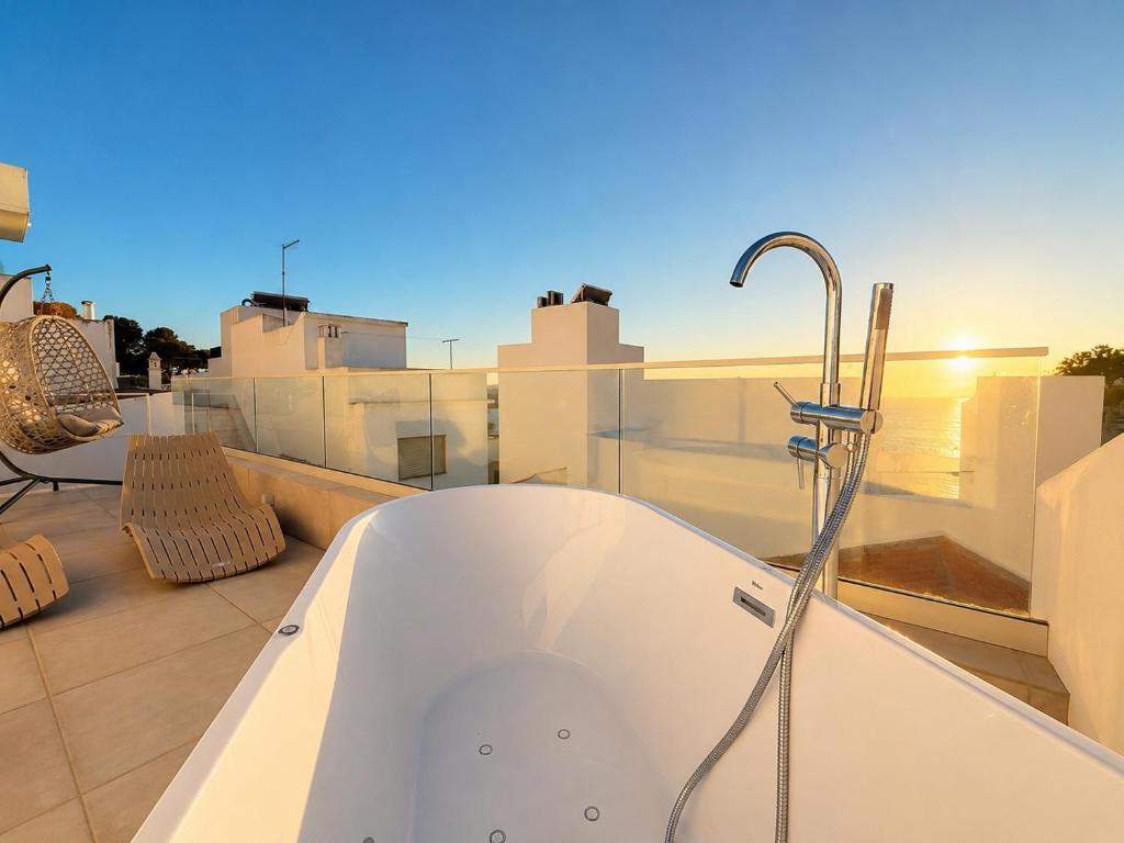 a bath tub sitting on top of a roof at Coral Alvor Old Town Marina Townhouses Collection in Alvor