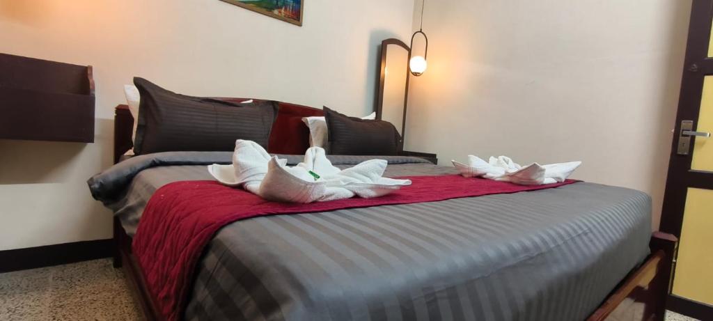 a bedroom with a bed with white pillows on it at COCHIN CINEMA Rooms in Cochin