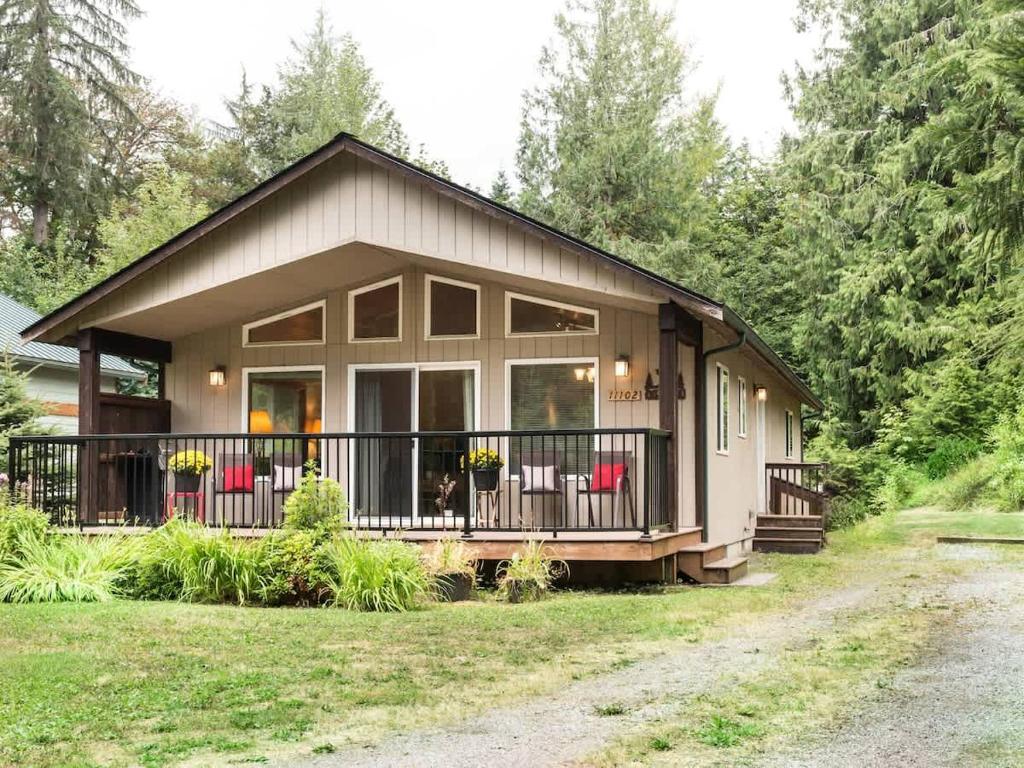 a small house with a porch and a balcony at Woodland Bungalow in Glacier
