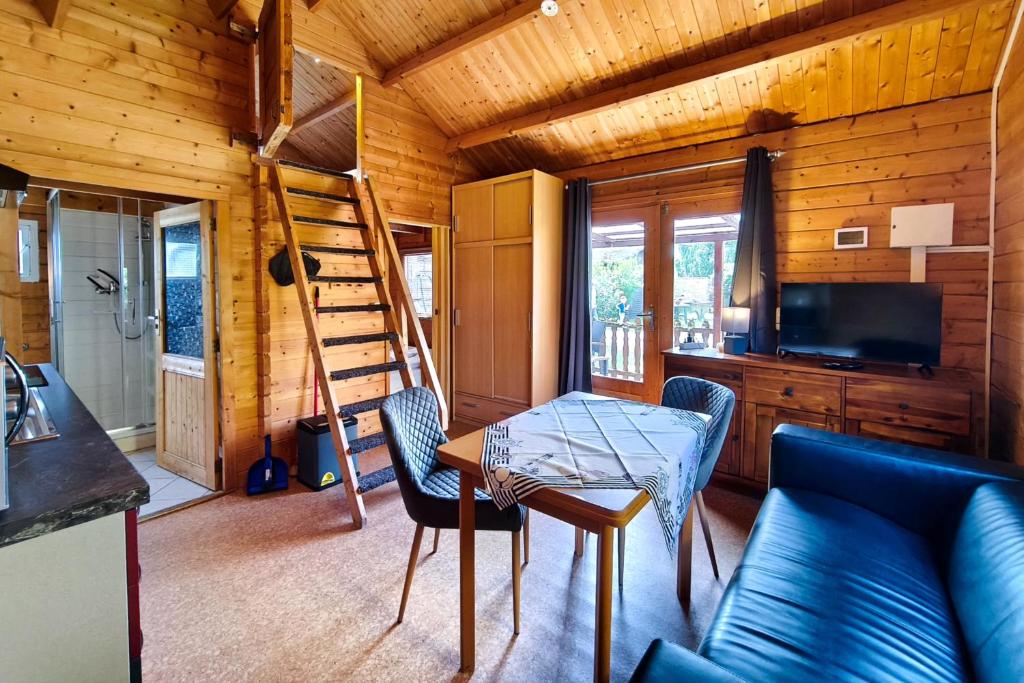 a living room with a couch and a table and a ladder at Ferienwohnung Reimann in Loddin