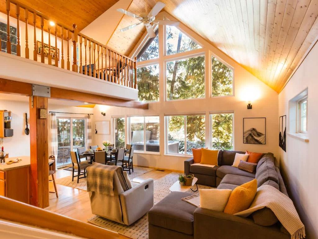 a large living room with a couch and chairs at Yverin Muse Cabin in Glacier