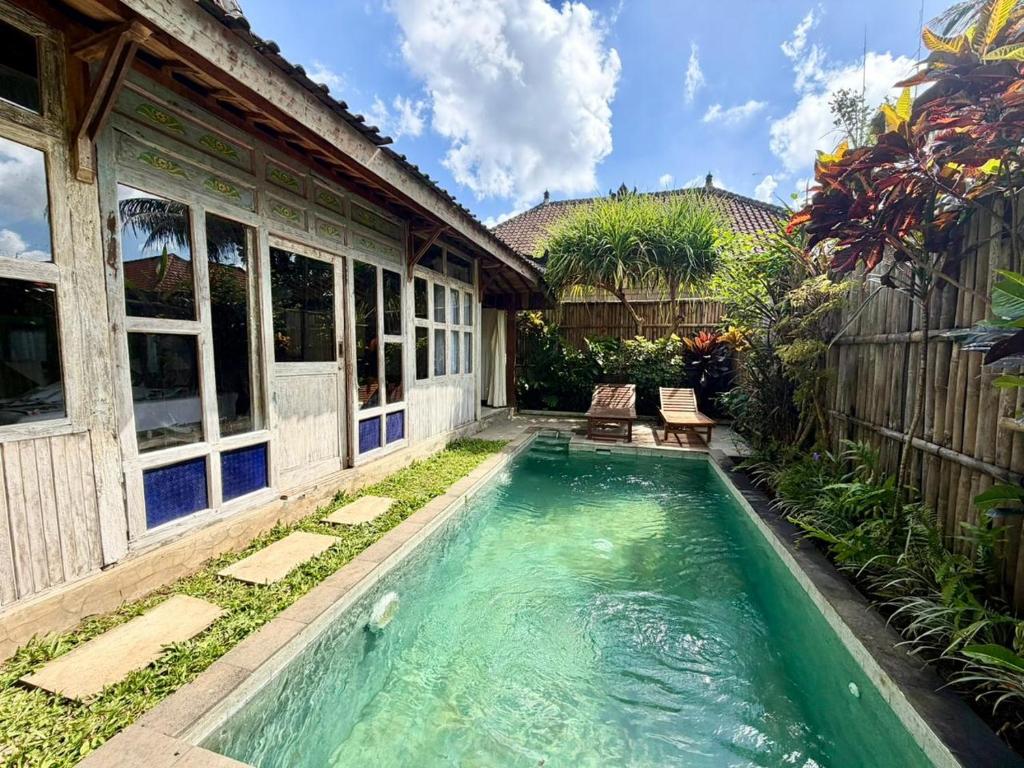 a swimming pool in the backyard of a house at Sarini Joglo Villa by Manara in Blahbatu