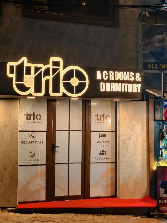 a store front with a sign for a store at Trio Rooms & dormitory in Trivandrum
