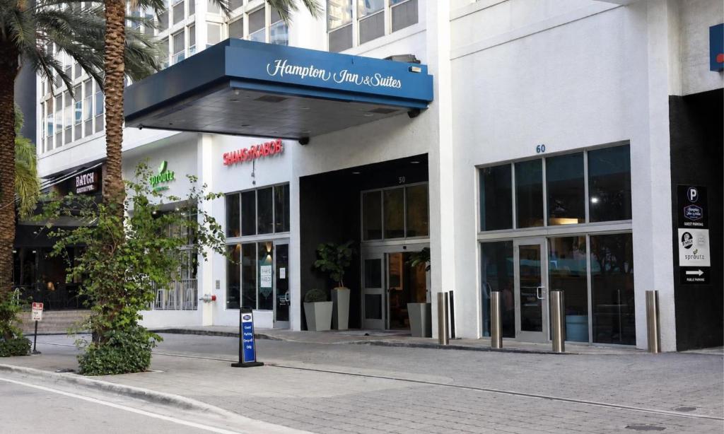 a building with a blue sign on the front of it at Hampton Inn & Suites by Hilton Miami Downtown/Brickell in Miami