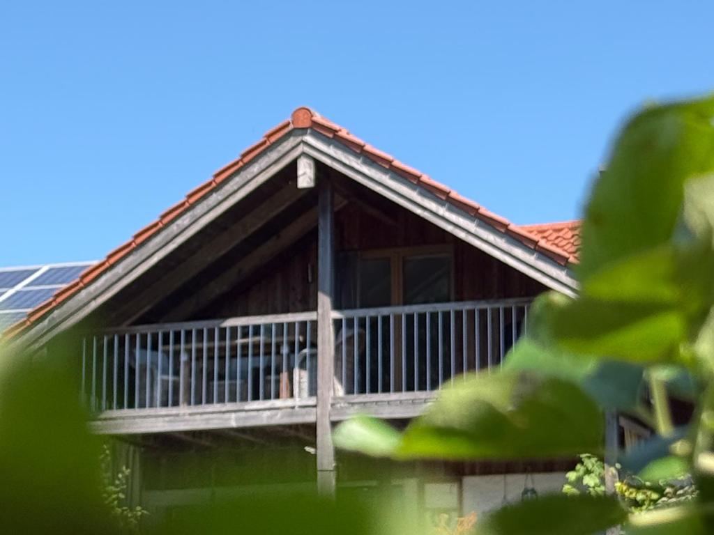 a house with a porch and a balcony at Haus am Bach in Roitham