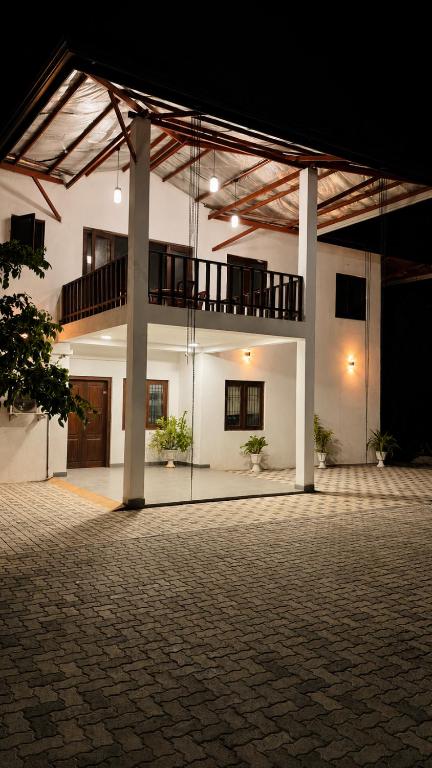 an empty courtyard of a building with a balcony at Prabha Garden Boutique Villa in Anuradhapura