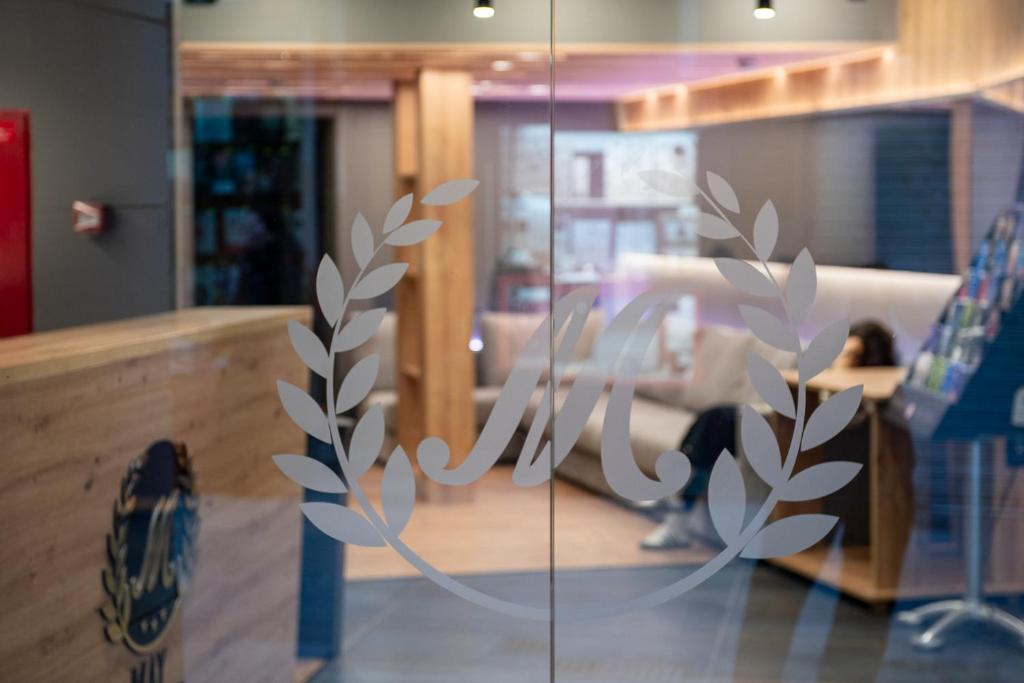 a sign on a glass door in a room at May Ramblas Hotel in Barcelona