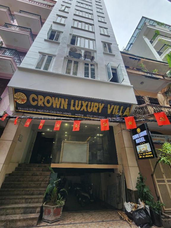a building with a sign on the front of a store at Crown Luxury Hotel in Hanoi