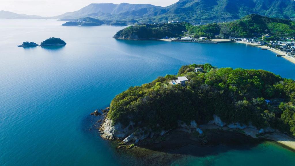 an island in the middle of a body of water at SHIMASTREAM house in Shodoshima