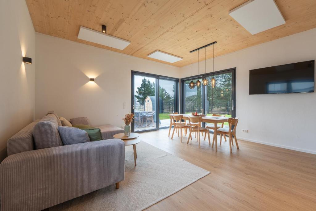 a living room with a couch and a table at Casa CaVi Bergheider See in Buschmühle