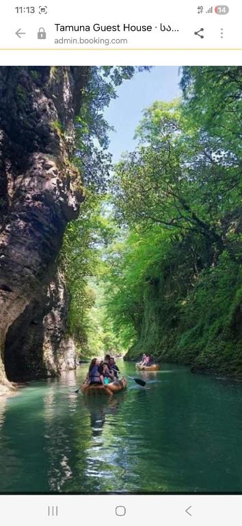 a group of people riding in boats in a river at Guest hous Tamuna in Martvili