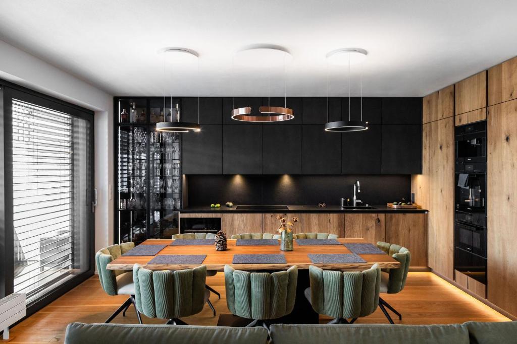 a dining room with a table and some chairs at MOLO LIPNO RESIDENCE in Lipno nad Vltavou