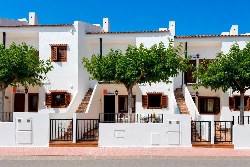 a white building with trees in front of it at Euromar I - TEPINSA Alquiler de Apartamentos in Torreblanca