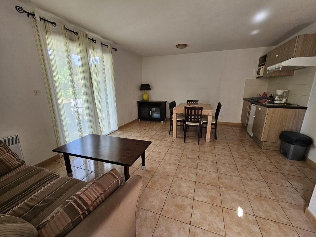 a living room with a couch and a table at Appartement T3 Barbaste in Barbaste