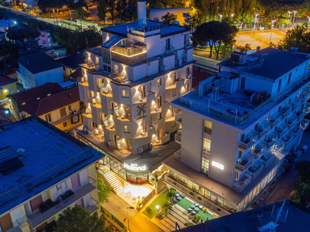 an aerial view of a white building at night at Hotel Holland in Rimini