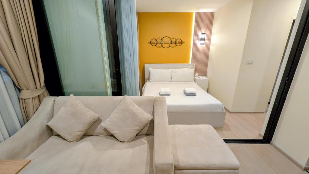 a small room with a bed and a couch at Boat Avenue condo in Bang Tao Beach