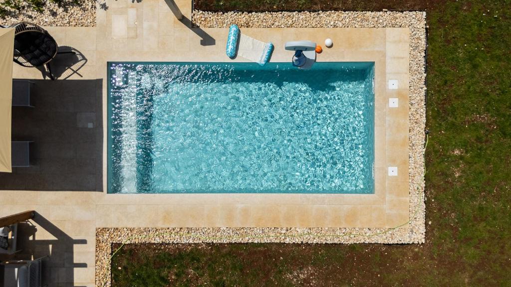 an overhead view of a swimming pool in a yard at House 61 in Milotski Breg
