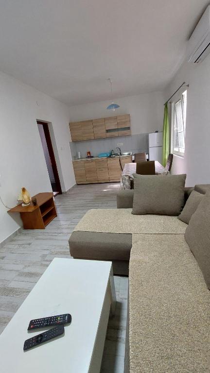 a living room with two couches and a remote control at UnaMar 1 in Prčanj