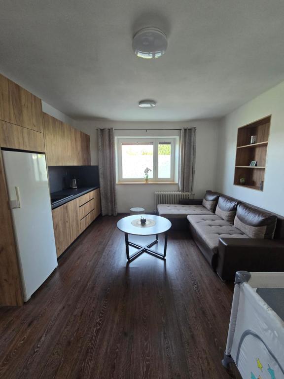 a living room with a couch and a table at Pod hradem in Choustníkovo Hradiště