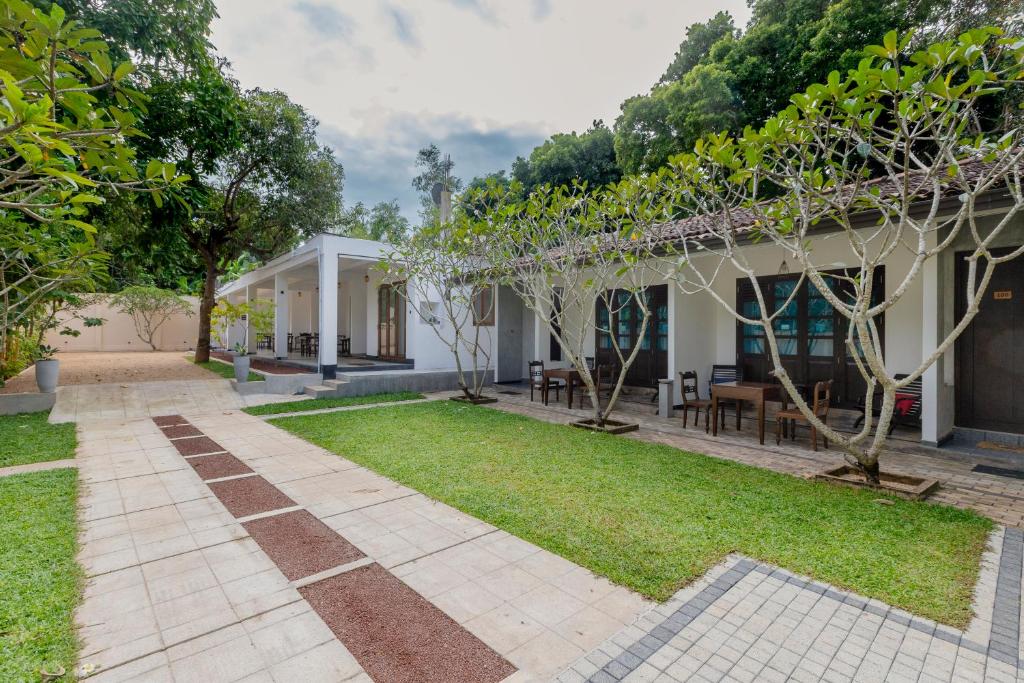 a house with a garden in front of it at Coastal Villa Mirissa in Mirissa