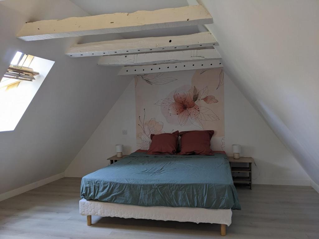 a bedroom with a bed in a attic at Le Petit Nid de Martel in Martel