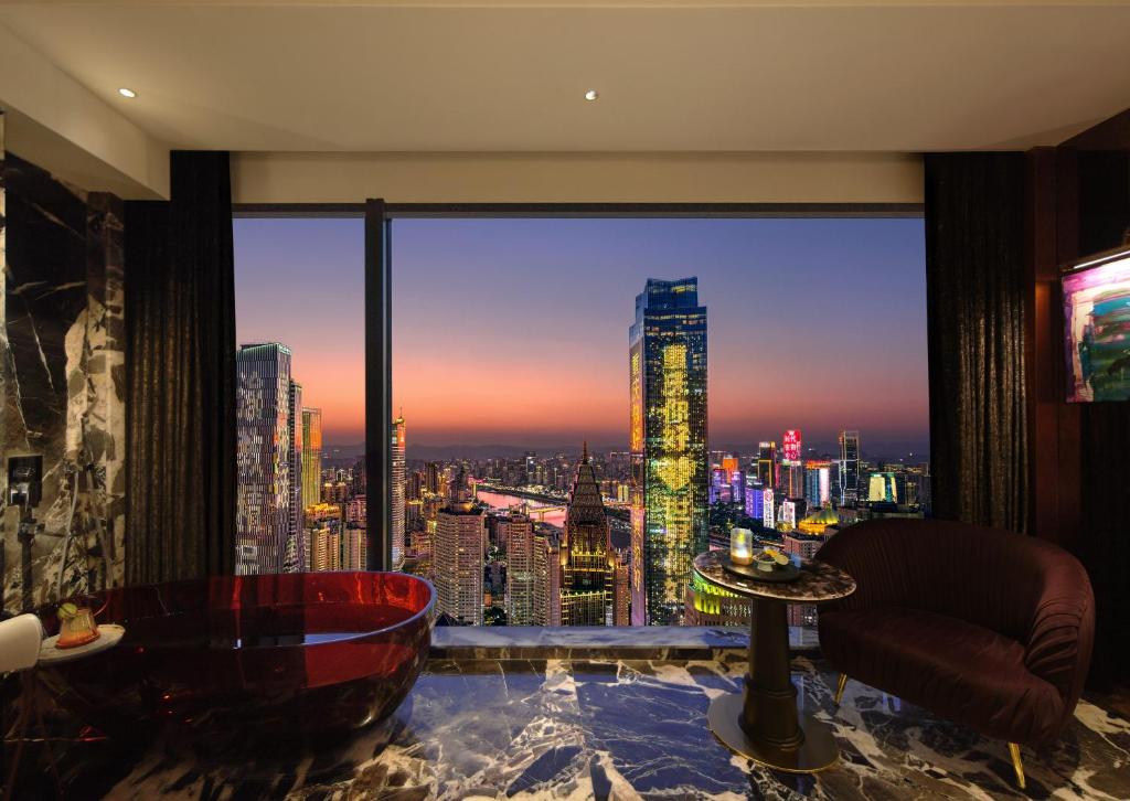 a room with a view of a city skyline at Aranciel 阿岚若 High-Rise River View Hotel -Jiefangbei Area-Hongya Cave in Chongqing